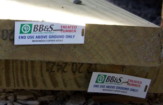The ends of two preservative-treated Southern Yellow Pine 2x10 boards on a Massachusetts job site. The labels on these boards indicate that the wood is not approved for contact with the ground. That’s rarely a problem in a deck framing situation; however, if the boards are used as stair stringers and with the lower ends touching the ground, the use is not approved or guaranteed. Premature rot of treated-wood stair stringers has been reported in that situation — particularly in coastal exposures and in hot humid climates.