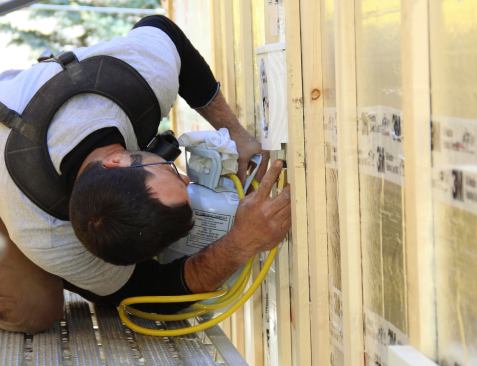 Pollard seals a vent penetration in the wall using a canister of expanding foam insulating sealant.