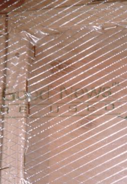 Most dense-pack cellulose systems require the installation of a reinforced polyethylene air barrier. Stapling the poly on the side rather than the edge of the studs helps keep the poly from bulging when the cellulose is blown in place.