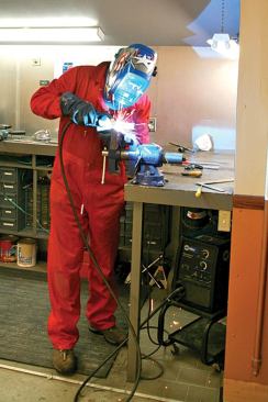 The wire and shielding gas feed through a relatively short (about 10 feet) hose, so the machine can't be placed too far away from the work.