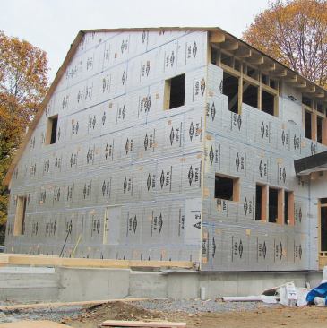 Before framing the unheated attached garage, the author applied foam sheathing to the common wall, establishing a thermal break between the two structures.