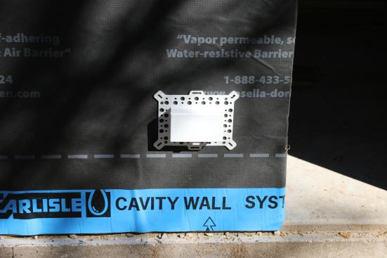 Here’s one installed, and the photo below is what it looks like inside the wall. They do stick inside the building by about 2?. (I’m using closed cell foam on this house to get an air seal from the box to the wires.)