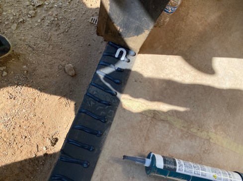 Doors are installed on horseshoe shims in a bed created by lines of fluid-applied that are spaced wide enough apart so there are channels between the smushed-out beads to allow water to drain. 