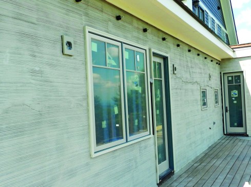 The entire first floor below the second-story beltline was stuccoed, including above the rear deck. Note: The standouts just below the soffit are for a ledger board that will support a trellis. With any cladding material, especially one like stone that can hold a considerable amount of water, it’s important to promote drainage and drying.