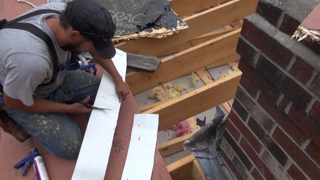 Cutting a piece of coasted aluminum coil stock flashing to length.