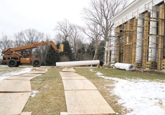 Sheets of 3/4-inch plywood protected the lawn from the lift that was used to transport and place the new columns..