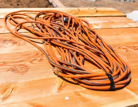 Power Cords. When I started framing I was taught it’s worth spending extra for high-quality cords. At that time we had Yellow Jacket cords, which stay flexible in the cold and were the first I had seen with a lighted receptacle end (important when the power trips in wet weather and we need to know if it’s the cord or tool that’s tripping the power). We use 12/3 100’ power cords; they’re heavier than a homeowner’s cord but last a long time. Currently, some of our 12/3 power cords are Yellow Jacket and some are Ridgid from Home Depot. They’re equally good and if I was buying today I’d go with whichever cost less.