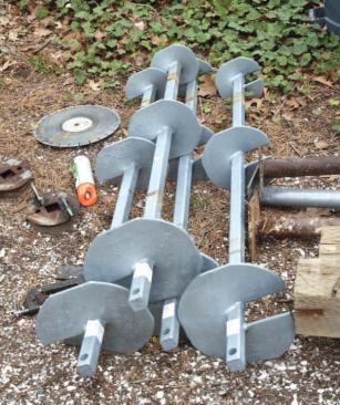Because of the steep slope and difficult access, the helical piers and extension shafts were driven using a custom-made steel frame to support the auger head.
