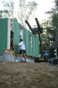 The framing crew places a wall that they'd built and then had trucked in for the Blitz