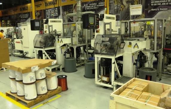 Some of the brushed motors used at the assembly plant are assembled and wound at the factory. The machines you see here (there are two of them) are used to make armatures by wrapping copper wire around the metal plates in the armature stack. It happens so fast you can barely see it. The spools on the pallet contain wire. They are unwrapped, placed under the upside-down trash cans and fed from there into the winding machines. I do not know where the stators are made.