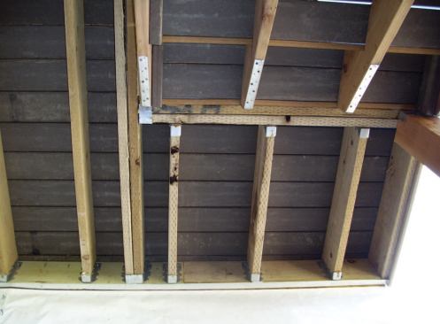 Because a doubled joist that supports other joists transfers a concentrated load to the ledger, it will require support beyond the code's bolting schedule. Some inspectors will make an exception for a small stair landing, while others will prohibit all beams from loading at the ledger.