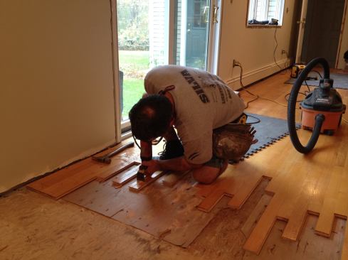 To finish staggering the ends of the boards, Manny cuts back to the lines he made earlier with an oscillatiing tool.