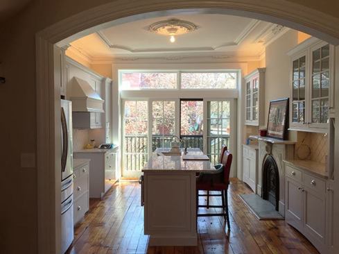 We sanded and finished the existing plank flooring throughout the upper floors, including the kitchen. The existing fireplace in the kitchen is not functioning. However, we did convert the fireplaces in the master bedroom and living room to gas-fired units, which we vented to the roof, installing fresh-air intakes, as well.