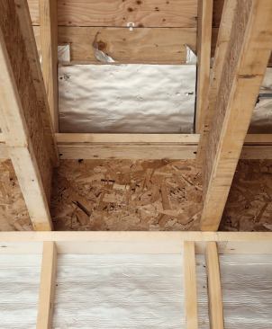 Foam-board vent baffles prevent wind-washing of the cellulose insulation in the attic ceiling areas.