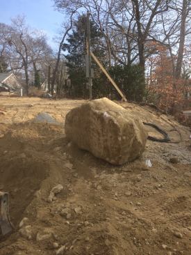 Excavation for the septic system uncovers the same poor soil with poor drainage and rocks like this one. George has to remove more than 1,100 yards of material and brings in 670 yards of sand to install the septic system.