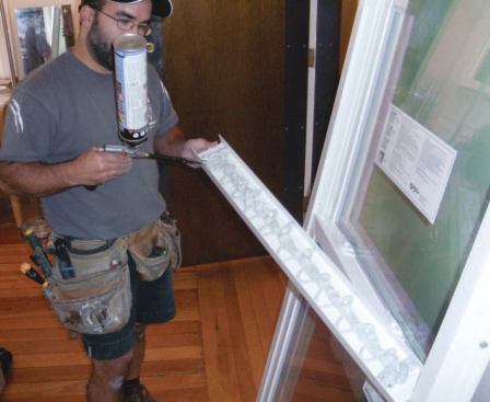 At this point I prep the window for installation by tapping in the bottom expander and insulating the hollow extrusion as much as possible with low-expansion spray foam. I do the same with the top expander before fitting it to the top of the unit.
