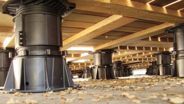 A series of adjustable plastic pedestals, each rated for a 1,500-pound load, hold up the deck. This support system makes it possible to clean leaves and debris from under the deck, or make adjustments.