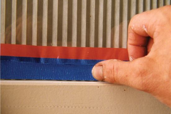 The author is careful to leave a slight, even gap between the tape and glazing trim