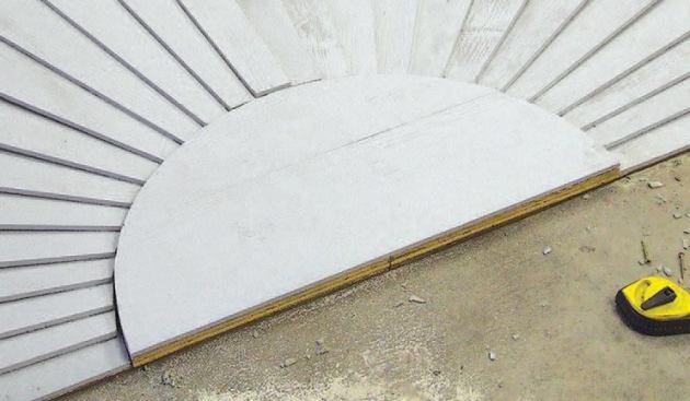 I cut them out with a jigsaw fitted with a carbide tile blade, which works well for cutting fiber-cement siding.