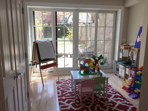 The slider unit makes the garden-level kid’s room a bright and inviting play space. We installed light-colored engineered-wood flooring (gluing it to the slab) to further add to the brightness.