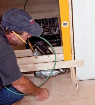 The author shims the hinge jamb first, directly behind hinge locations and at top and bottom.