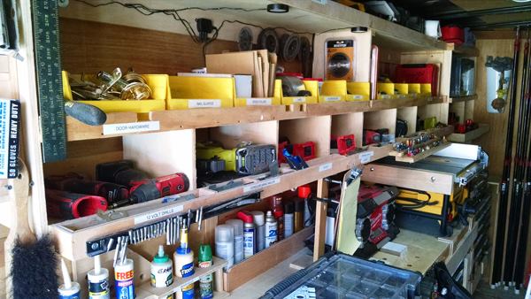 The left side of the trailer contains a bench/work table and shelves and storage for tools, supplies, and equipment. Note the way everything is labeled.