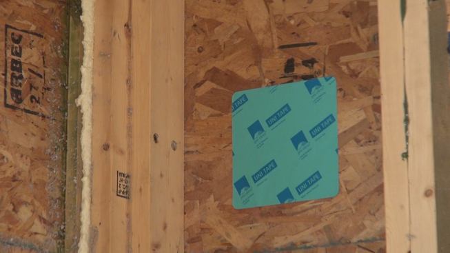 Most of the field-insulated panel-to-panel joints were insulated with dense-pack cellulose from the inside of the building, through holes drilled in the building’s OSB air barrier. Here, Pro Clima Uni Tape patch has been used to seal one of the field-drilled insulation holes.