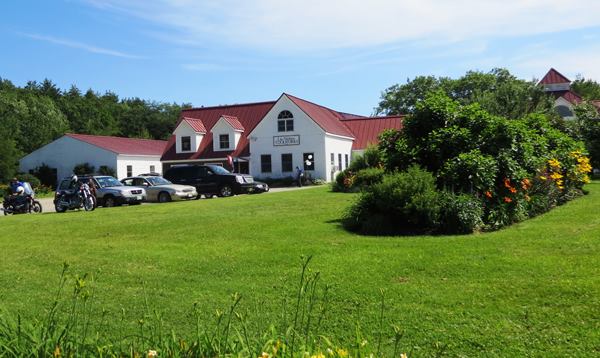 This is a view from the front. The narrow building on the far left is a production facility. The part with the dormers is the retail store. The largest part of the facility is off to the right; you can just make out the cupola on top of the demo room.