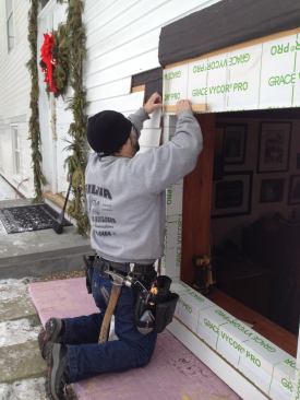 Like the rest of the pieces of flashing tape, the head flashing tucks behind the clapboard where it needs to.