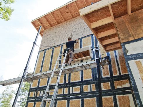 The author applied strips of Vycor membrane at stud locations to ensure that the fasteners securing the vertical I-joists would not create leaks in the OSB air barrier.