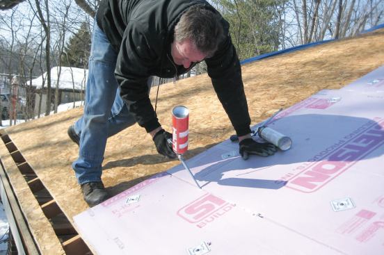 Applying foam atop the roof's sheathing was the least expensive way to add needed insulation to this home's vaulted ceilings.