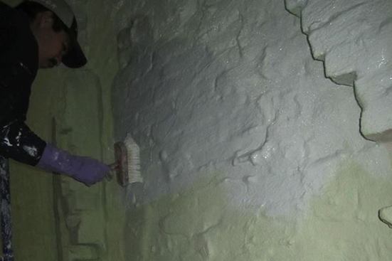 A worker applies Sto Emerald Cote to a masonry wall as part of the remodel of a Brooklyn brick row house. The Sto Cote is vapor open, but air tight, says Passive House consultant Cramer Silkworth.
