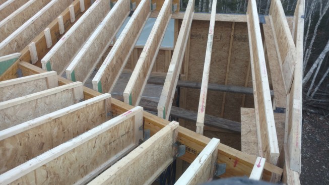Where the I-joist rafters meet the doubled-up LVL valley rafter, the I-joists stand about 4 inches proud, leaving space for insulation above the valley member to reduce the risk of melting snow and formationof ice in winter.