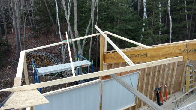 The custom-designed windows specified for this end of the house aren’tsquare at the top, but instead have one corner higher than the other and no window casing.
