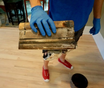 Troweling method. Mike Somodean, a floor refinishing contractor based in Roswell, Ga., shows the  flexible trowel he uses to apply hardening oil. 
