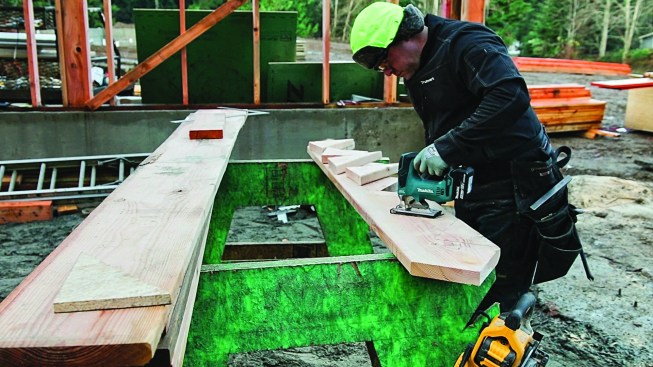 He is careful not to overcut, finishing each step with a jigsaw.