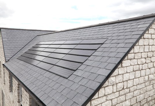 A new set of solar panels which blend in nicely with a black tiled roof.