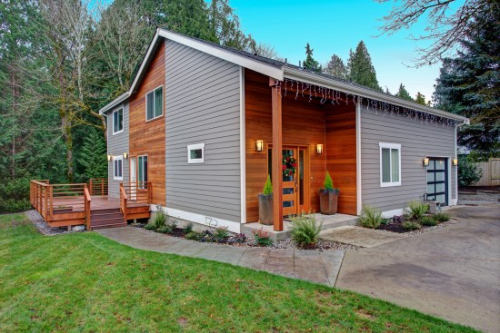 Charming newly renovated home exterior, natural wood siding and grey siding help to encrease curb appeal.