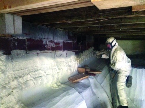 Spray foam in the basement cut the heat loss to the ground, as well as limiting the building’s vapor load. A foam application sealed the ground vapor barrier to the wall.