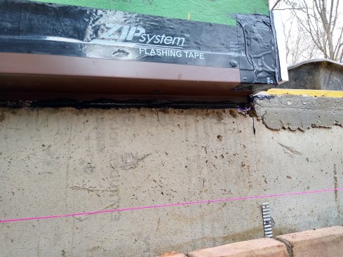 This home had two major renovations in its 46-year existence. We used different approaches to match different circumstances. In this area, a large overhang resulted from adding R-16 to the exterior (the interior of this area remained intact); we air-sealed the overhang with a site-bent flashing and Zip Liquid Flash caulking. Zip Flashing Tape seals the top edge of the flashing and the Zip areas.