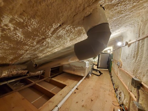 There are three separate attics with three separate access points. This one was the smallest. The air-barrier here consists of 1 1/2-inch XPS foam that we cut into the rafter bays to create a 1-inch ventilation space below the roof sheathing. We do not rely on the closed-cell foam as a singular air barrier.