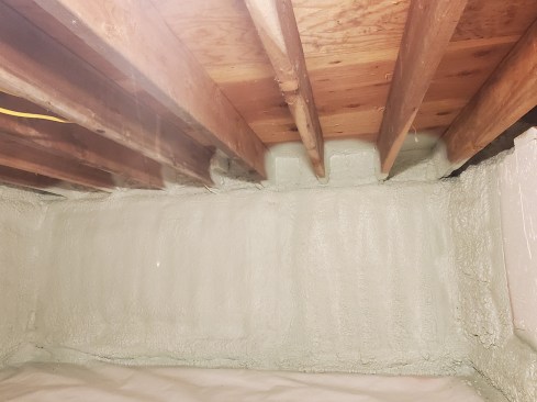 In areas where we did have access from inside, we insulated and air-sealed the rim-joist sill first with Sashco Big Stretch to seal all connections to the sill plate and rim joist. Prior to spray-foaming, we added 2-inch blocks of Rockwool Comfortboard over the rim joist. This vapor-open buffer zone allows moisture to dissipate into neighboring materials and dry into the building 