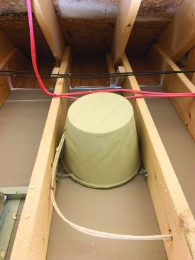 The author protects can lights in the attic using Tenmat mineral-wool hats.