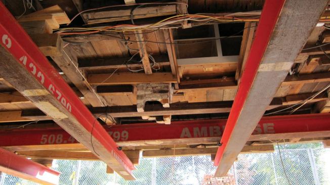 To pick up the chimney load, we punched a hole through the brick and flue tile and slid a scrap of tube steel through it (10). The standard alternating brick courses transferred the stresses and effectively held the chimney intact with no further reinforcement.