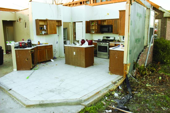 This kitchen wall was not fastened down with anchor bolts, but only with powder-actuated nails.