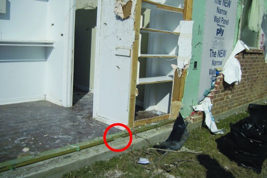 Nails used to fasten another detached wall plate do not appear to have penetrated the concrete when the plate was installed.