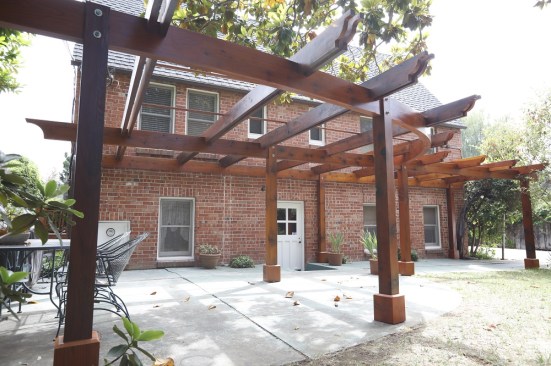 After assembling the arbor, the author gave all of the components a final coat of finish, and installed 2x2 vine holders on top of the purlins.
