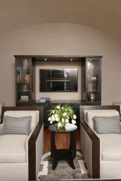 Arch-Interiors designed and constructed this custom hand-finished iron shelf as a sophisticated yet functional accent to the refreshed living space. 