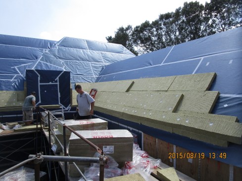 Here's another look at the roof insulation job in progress, showing staggered courses of 2-foot by four-foot, three-inch-thick Roxul rock wool insulation batts.