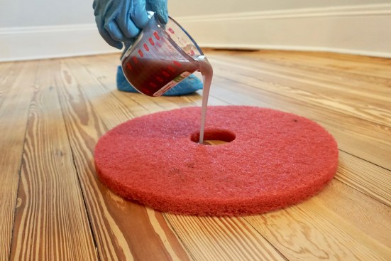 Once the perimeter is cut in, the author fills the center of a red pad with enough oil for a manageable section.